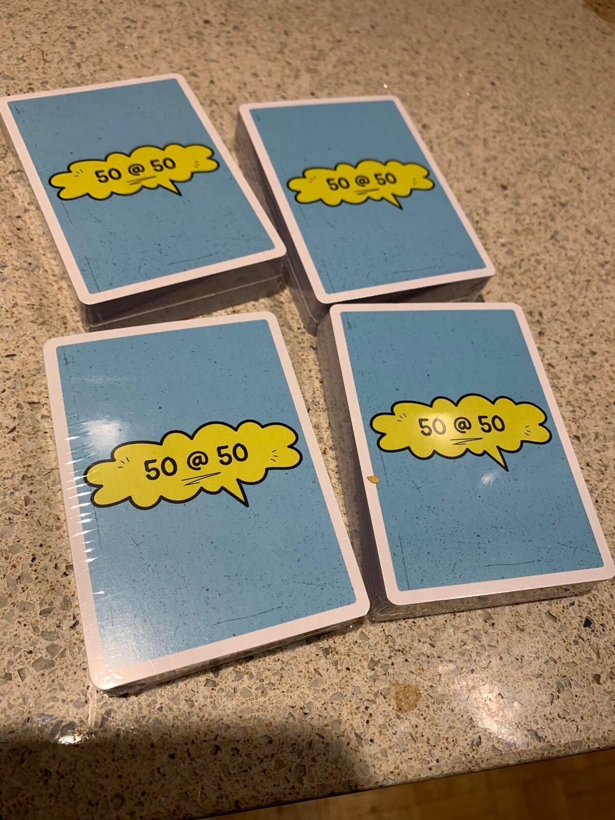 Stacks of the 50 @ 50 reflection card deck